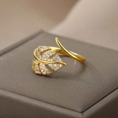 Elegant gold palm leaf ring made of stainless steel with shimmering zircon details.