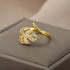 Elegant gold palm leaf ring made of stainless steel with shimmering zircon details.