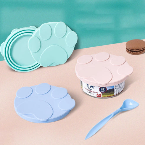 "Close-up of flexible silicone pet food lid with integrated spoon for easy scooping and sealing.