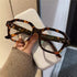 Unisex retro-inspired eyeglasses with anti-blue light lenses and a sturdy frame.