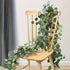 Lush 70.8-inch artificial eucalyptus garland featuring delicate white flowers.