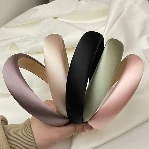 Soft satin silk hairband in solid color, wide design for comfort.