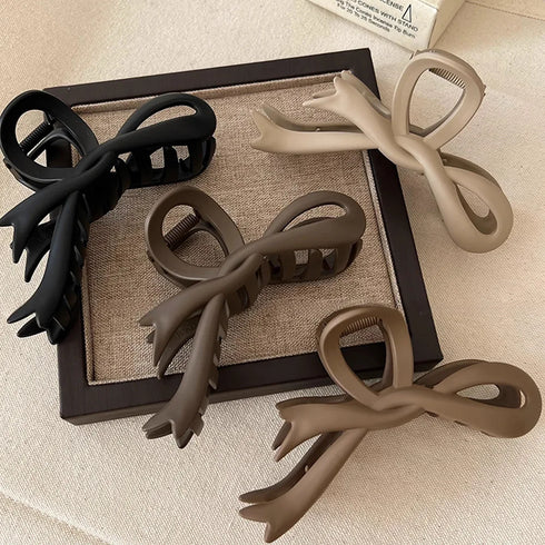 Sleek vintage-style matte bow hair clip for women, ideal for holding hair in a stylish updo or ponytail.